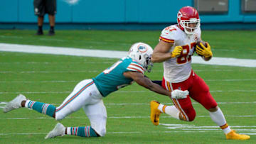 MIAMI GARDENS, FLORIDA - DECEMBER 13: Eric Rowe #21 of the Miami Dolphins tackles Travis Kelce #87 of the Kansas City Chiefs during the first half of the game at Hard Rock Stadium on December 13, 2020 in Miami Gardens, Florida. (Photo by Mark Brown/Getty Images)