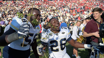 Nov 26, 2016; Athens, GA, USA; Georgia Tech Yellow Jackets offensive lineman Freddie Burden (58) and running back Dedrick Mills (26) react with handfuls of the Sanford Stadium hedges after defeating the Georgia Bulldogs at Sanford Stadium. Georgia Tech defeated Georgia 28-27. Mandatory Credit: Dale Zanine-USA TODAY Sports
