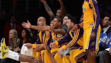 Oct 29, 2013; Los Angeles, CA, USA; Los Angeles Lakers shooting guard Nick Young (0) is charged with an offensive foul as the bench reacts in the first half of the game against the Los Angeles Clippers at the at Staples Center. Mandatory Credit: Jayne Kamin-Oncea-USA TODAY Sports