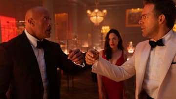RED NOTICE - (L-R) Dwayne Johnson is the FBI’s top profiler John Hartley, Gal Gadot is the world’s most wanted art thief “The Bishop” and Ryan Reynolds is the world’s greatest art thief Nolan Booth in Netflix's RED NOTICE. Directed and written by Rawson Marshall Thurber, RED NOTICE is releasing November 12, 2021. Cr: Frank Masi / Netflix © 2021