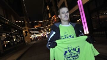 Nov 27, 2013; Cleveland, OH, USA; James Blair poses with a "Come Home LeBron" t-shirt before the game between the Cleveland Cavaliers and the Miami Heat at Quicken Loans Arena. Mandatory Credit: David Richard-USA TODAY Sports