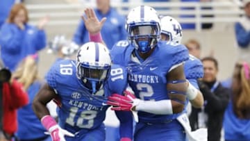 Oct 11, 2014; Lexington, KY, USA; Kentucky Wildcats running back Stanley Williams (18) celebrates with wide receiver Dorian Baker (2) after scoring a touchdown against the Louisiana-Monroe Warhawks in the second half at Commonwealth Stadium. Kentucky defeated Louisiana-Monroe 48-14. Mandatory Credit: Mark Zerof-USA TODAY Sports