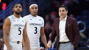 Cincinnati Bearcats head coach Wes Miller meets with guards David DeJulius and Mika Adams-Woods against Tulsa Golden Hurricane at Fifth Third Arena. Getty Images.