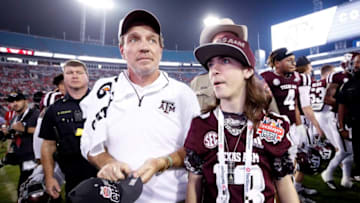 JACKSONVILLE, FL - DECEMBER 31: Head coach Jimbo Fisher of the Texas A&M Aggies with his son Ethan after a win against the North Carolina State Wolfpack in the TaxSlayer Gator Bowl at TIAA Bank Field on December 31, 2018 in Jacksonville, Florida. Texas A&M won 52-13. (Photo by Joe Robbins/Getty Images)
