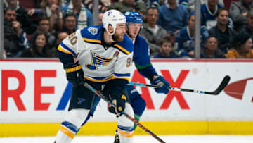 VANCOUVER, BC - NOVEMBER 05: Ryan O'Reilly #90 of the St. Louis Blues looks to make a pass while checked by J.T. Miller #9 of the Vancouver Canucks during NHL action at Rogers Arena on November 5, 2019 in Vancouver, Canada. (Photo by Rich Lam/Getty Images)