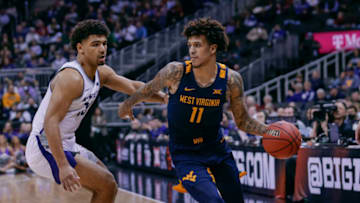 KANSAS CITY, MO - MARCH 09: Jalen Bridges #11 of the West Virginia Mountaineers dribbles the ball against Mark Smith #13 of the Kansas State Wildcats at T-Mobile Center on March 10, 2022 in Kansas City, Missouri. (Photo by Michael Hickey/Getty Images)