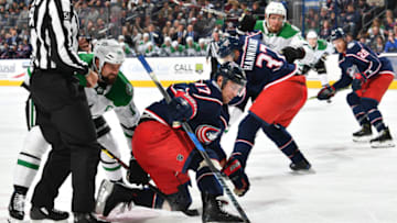 COLUMBUS, OH - NOVEMBER 6: Brandon Dubinsky #17 of the Columbus Blue Jackets reaches for the puck following a face-off against Jamie Benn #14 of the Dallas Stars during the second period of a game on November 6, 2018 at Nationwide Arena in Columbus, Ohio. (Photo by Jamie Sabau/NHLI via Getty Images)