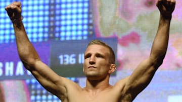 LAS VEGAS, NV - JULY 08: Mixed martial artist TJ Dillashaw poses on the scale during his weigh-in for UFC 200 at T-Mobile Arena on July 8, 2016 in Las Vegas, Nevada. Dillashaw will meet Raphael Assuncao in a bantamweight bout on July 9 at T-Mobile Arena. (Photo by Ethan Miller/Getty Images)