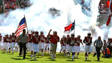 RALEIGH, NC - SEPTEMBER 29: Head coach Dave Doeren (C) of the North Carolina State Wolfpack leads his team onto the field prior to their game against the Virginia Cavaliers at Carter-Finley Stadium on September 29, 2018 in Raleigh, North Carolina. (Photo by Lance King/Getty Images)