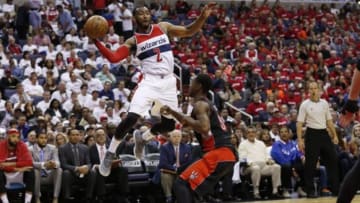 Apr 24, 2015; Washington, DC, USA; Washington Wizards guard John Wall (2) leaps to pass the ball over Toronto Raptors forward James Johnson (3) in the second quarter in game three of the first round of the NBA Playoffs at Verizon Center. Mandatory Credit: Geoff Burke-USA TODAY Sports
