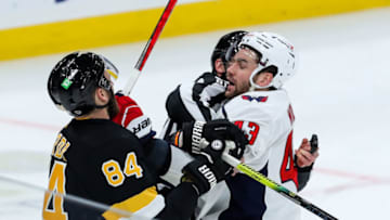 Mar 5, 2021; Boston, Massachusetts, USA; Boston Bruins defenseman Jarred Tinordi (84) and Washington Capitals right wing Tom Wilson (43) fight during the first period at TD Garden. Mandatory Credit: Paul Rutherford-USA TODAY Sports