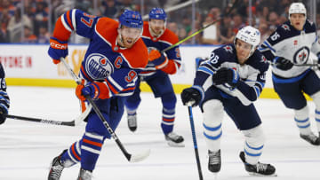 Oct 21, 2023; Edmonton, Alberta, CAN; Edmonton Oilers forward Connor McDavid (97) carries the puck around Winnipeg Jets forward Morgan Barron (36) during the third period at Rogers Place. Mandatory Credit: Perry Nelson-USA TODAY Sports