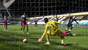 NEWCASTLE UPON TYNE, ENGLAND - JULY 05: Jonjo Shelvey of Newcastle United scores his team's second goal past Lukasz Fabianski of West Ham United during the Premier League match between Newcastle United and West Ham United at St. James Park on July 05, 2020 in Newcastle upon Tyne, England. Football Stadiums around Europe remain empty due to the Coronavirus Pandemic as Government social distancing laws prohibit fans inside venues resulting in games being played behind closed doors. (Photo by Michael Regan/Getty Images)