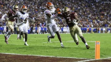 TALLAHASSEE, FLORIDA - NOVEMBER 25: Trey Benson #3 of the Florida State Seminoles scores a touchdown against Jason Marshall Jr. #3 of the Florida Gators during the second half of a game at Doak Campbell Stadium on November 25, 2022 in Tallahassee, Florida. (Photo by James Gilbert/Getty Images)