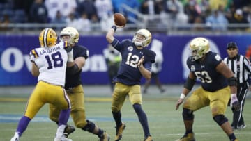 3ORLANDO, FL - JANUARY 01: Ian Book #12 of the Notre Dame Fighting Irish throws for the game-winning 55-yard touchdown to Miles Boykin in the fourth quarter of the Citrus Bowl against the LSU Tigers on January 1, 2018 in Orlando, Florida. Notre Dame won 21-17. (Photo by Joe Robbins/Getty Images)