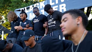 CLEMSON, SOUTH CAROLINA - JUNE 13: Clemson University football players Trevor Lawrence, Darien Rencher, Cornell Powell, and Mike Jones Jr., pray following the "March for Change" protest at Bowman Field on June 13, 2020 in Clemson, South Carolina. The protests were in response to the death of George Floyd, an African American, while in the custody of the Minneapolis police. Protests calling for an end to police brutality have spread across cities in the U.S., and in other parts of the world. (Photo by Maddie Meyer/Getty Images)