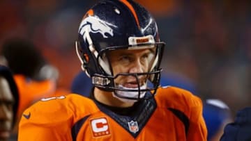 Jan 11, 2015; Denver, CO, USA; Denver Broncos quarterback Peyton Manning (18) after their loss to the Indianapolis Colts in the 2014 AFC Divisional playoff football game at Sports Authority Field at Mile High. The Colts won 24-13. Mandatory Credit: Chris Humphreys-USA TODAY Sports