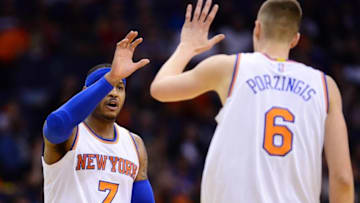 Mar 9, 2016; Phoenix, AZ, USA; New York Knicks forward Carmelo Anthony (7) high fives forward Kristaps Porzingis (6) in the first half against the Phoenix Suns at Talking Stick Resort Arena. Mandatory Credit: Jennifer Stewart-USA TODAY Sports