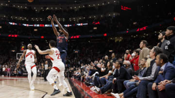 TORONTO, ON - APRIL 20: Joel Embiid #21 of the Philadelphia 76ers puts up a shot over Precious Achiuwa #5 and Fred VanVleet #23 of the Toronto Raptors in the final seconds of overtime in Game Three of the Eastern Conference First Round at Scotiabank Arena on April 20, 2022 in Toronto, Canada. NOTE TO USER: User expressly acknowledges and agrees that, by downloading and or using this Photograph, user is consenting to the terms and conditions of the Getty Images License Agreement. (Photo by Cole Burston/Getty Images)