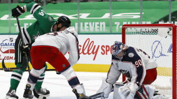 DALLAS, TEXAS - APRIL 15: Elvis Merzlikins #90 of the Columbus Blue Jackets blocks a shot on goal against Jamie Benn #14 of the Dallas Stars in the second period at American Airlines Center on April 15, 2021 in Dallas, Texas. (Photo by Tom Pennington/Getty Images)