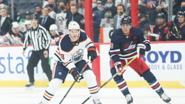 Nov 16, 2021; Winnipeg, Manitoba, CAN; Edmonton Oilers forward Zack Hyman(18) skates away from Winnipeg Jets forward Blake Wheeler (26) during the first period at Canada Life Centre. Mandatory Credit: Terrence Lee-USA TODAY Sports