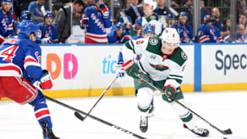 NEW YORK, NY - FEBRUARY 21: Ryan Donato #6 of the Minnesota Wild skates with the puck against Neal Pionk #44 of the New York Rangers at Madison Square Garden on February 21, 2019 in New York City. (Photo by Jared Silber/NHLI via Getty Images)