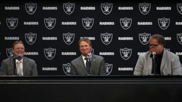ALAMEDA, CA - JANUARY 09: (L-R) Oakland Raiders owner Mark Davis, Oakland Raiders new head coach Jon Gruden and Oakland Raiders general manager Reggie McKenzie look on during a news conference at Oakland Raiders headquarters on January 9, 2018 in Alameda, California. Jon Gruden has returned to the Oakland Raiders after leaving the team in 2001. (Photo by Justin Sullivan/Getty Images)