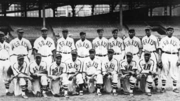 PITTSBURGH - 1942. The Homestead Grays Negro League baseball club pose for a team shot in their home park, Forbes Field in Pittsburgh, in 1942. Hall of Fame members on the club include Josh Gibson, standing, third from left and Buck Leonard, standing, far right, (Photo by Mark Rucker/Transcendental Graphics, Getty Images)