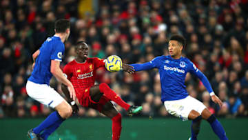 LIVERPOOL, ENGLAND - DECEMBER 04: Sadio Mane of Liverpool controls the ball under pressure from Mason Holgate and Michael Keane of Everton during the Premier League match between Liverpool FC and Everton FC at Anfield on December 04, 2019 in Liverpool, United Kingdom. (Photo by Clive Brunskill/Getty Images)