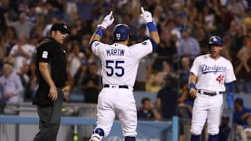 LOS ANGELES, CALIFORNIA - SEPTEMBER 03: Russell Martin #55 of the Los Angeles Dodgers celebrates as he approaches home plate after hitting a three-run home run in the seventh inning as teammate Matt Beaty #45 and home plate umpire Dan Bellino #2 look on during the MLB game between the Colorado Rockies and the Los Angeles Dodgers at Dodger Stadium on September 03, 2019 in Los Angeles, California. (Photo by Victor Decolongon/Getty Images)