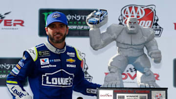 DOVER, DE - JUNE 04: Jimmie Johnson, driver of the #48 Lowe's Chevrolet, poses with the trophy in Victory Lane after winning the Monster Energy NASCAR Cup Series AAA 400 Drive for Autism at Dover International Speedway on June 4, 2017 in Dover, Delaware. (Photo by Jonathan Ferrey/Getty Images)