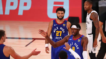 LAKE BUENA VISTA, FLORIDA - AUGUST 12: Jerami Grant #9 of the Denver Nuggets celebrates with teammates after making a basket while being fouled by the Denver Nuggets in the third quarter at AdventHealth Arena at ESPN Wide World Of Sports Complex on August 12, 2020 in Lake Buena Vista, Florida. NOTE TO USER: User expressly acknowledges and agrees that, by downloading and or using this photograph, User is consenting to the terms and conditions of the Getty Images License Agreement. (Photo by Kim Klement-Pool/Getty Images)