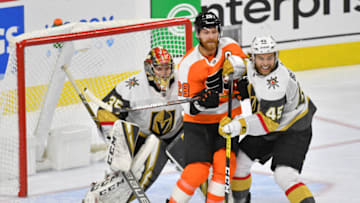 Oct 21, 2019; Philadelphia, PA, USA; Philadelphia Flyers right wing Claude Giroux (28) and Vegas Golden Knights defenseman Jake Bischoff (45) battle for position in front of goaltender Oscar Dansk (35) during the third period at Wells Fargo Center. Mandatory Credit: Eric Hartline-USA TODAY Sports