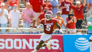 Oct 10, 2020; Dallas, Texas, USA; Oklahoma Sooners running back T.J. Pledger (5) runs wide against the Texas Longhorns during the first quarter of the Red River Showdown at Cotton Bowl. Mandatory Credit: Andrew Dieb-USA TODAY Sports
