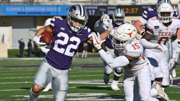 MANHATTAN, KS - DECEMBER 05: Running back Deuce Vaughn #22 of the Kansas State Wildcats rushes for a first down against pressure from defensive back Chris Brown #15 of the Texas Longhorns, during the second half at Bill Snyder Family Football Stadium on December 5, 2020 in Manhattan, Kansas. (Photo by Peter Aiken/Getty Images)