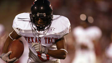 NORMAN, OK - NOVEMBER 23: Wide receiver Nehemiah Glover #6 of the Texas Tech University Red Raiders carries the ball during against the University of Oklahoma Sooners during the game at Memorial Stadium on November 23, 2002 in Norman, Oklahoma. The Sooners won 60-15 to advance to the Big 12 Championship. (Photo by Brian Bahr/Getty Images)