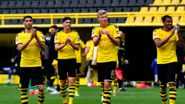 Dortmund's Norwegian forward Erling Braut Haaland (C) celebrates with his teammates their victory 4:0 after the German first division Bundesliga football match BVB Borussia Dortmund v Schalke 04 on May 16, 2020 in Dortmund, western Germany as the season resumed following a two-month absence due to the novel coronavirus COVID-19 pandemic. (Photo by Martin Meissner / POOL / AFP) / DFL REGULATIONS PROHIBIT ANY USE OF PHOTOGRAPHS AS IMAGE SEQUENCES AND/OR QUASI-VIDEO (Photo by MARTIN MEISSNER/POOL/AFP via Getty Images)