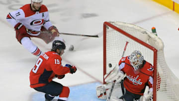 WASHINGTON, DC - APRIL 24: Carolina Hurricanes center Jordan Staal (11), left, and /Washington Capitals center Nicklas Backstrom (19) each Washington Capitals goaltender Braden Holtby (70) block a 3rd period shot during a game between the the Washington Capitals and the Carolina Hurricanes in game 7 of the the Stanley Cup eastern division quarter finals at 3 games each in Washington, DC on April 24, 2019 . (Photo by John McDonnell/The Washington Post via Getty Images)
