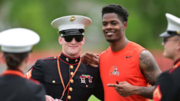 May 25, 2022; Berea, OH, USA; Cleveland Browns cornerback Greedy Williams (26) poses for a photo with a member of the military during organized team activities at CrossCountry Mortgage Campus. Mandatory Credit: Ken Blaze-USA TODAY Sports