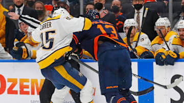 Edmonton Oilers forward Jesse Puljujarvi (13) hits Nashville Predators defensemen Alex Carrier (45) Mandatory Credit: Perry Nelson-USA TODAY Sports