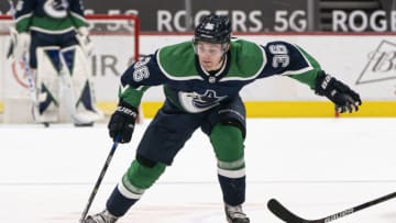 VANCOUVER, BC - FEBRUARY 19: Nils Hoglander #36 of the Vancouver Canucks skates with the puck during NHL hockey action against the Winnipeg Jets at Rogers Arena on February 19, 2021 in Vancouver, Canada. (Photo by Rich Lam/Getty Images)