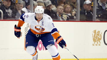 Mar 15, 2016; Pittsburgh, PA, USA; New York Islanders right wing Kyle Okposo (21) gathers the puck against the Pittsburgh Penguins during the third period at the CONSOL Energy Center. The Penguins won 2-1 in a shootout. Mandatory Credit: Charles LeClaire-USA TODAY Sports