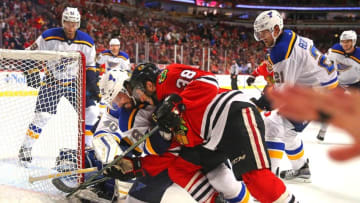 Oct 1, 2016; Chicago, IL, USA; Chicago Blackhawks right wing Ryan Hartman (38) and St. Louis Blues defenseman Morgan Ellis (78) fight for the puck in front of goalie Carter Hutton (40) during the second period of a preseason hockey game at the United Center. Mandatory Credit: Dennis Wierzbicki-USA TODAY Sports