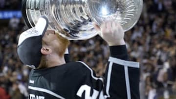 Jun 13, 2014; Los Angeles, CA, USA; Los Angeles Kings defenseman Matt Greene (2) kisses the Stanley Cup after defeating the New York Rangers in game five of the 2014 Stanley Cup Final at Staples Center. Mandatory Credit: Gary A. Vasquez-USA TODAY Sports