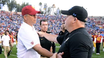 PASADENA, CALIFORNIA - NOVEMBER 17: Head coach Clay Helton of the USC Trojans shakes hands with head coach Chip Kelly of the UCLA Bruins after a 34-27 UCLA win at Rose Bowl on November 17, 2018 in Pasadena, California. (Photo by Harry How/Getty Images)