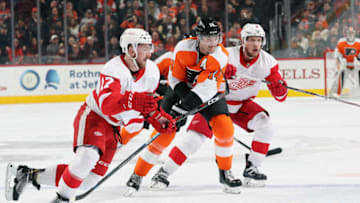 PHILADELPHIA, PA - DECEMBER 18: Sean Couturier #14 of the Philadelphia Flyers battles for position with Filip Hronek #17 and Justin Abdelkader #8 of the Detroit Red Wings on December 18, 2018 at the Wells Fargo Center in Philadelphia, Pennsylvania. (Photo by Len Redkoles/NHLI via Getty Images)