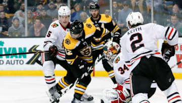 BOSTON, MA - MARCH 10: Boston Bruins right wing Brian Gionta (12) tries to get a shot on Chicago Blackhawks goalie Jean-Francois Berube (34) during a game between the Boston Bruins and the Chicago Blackhawks on March 10, 2018, at TD Garden in Boston, Massachusetts. The Bruins defeated the Blackhawks 7-4. (Photo by Fred Kfoury III/Icon Sportswire via Getty Images)