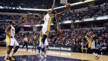 Nov 4, 2014; Indianapolis, IN, USA; Milwaukee Bucks guard Brandon Knight (11) lays the ball in against Indiana Pacers forward Lavoy Allen (5) at Bankers Life Fieldhouse. Mandatory Credit: Brian Spurlock-USA TODAY Sports
