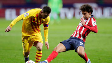 MADRID, SPAIN - NOVEMBER 21: Lionel Messi of FC Barcelona is challenged by Joao Felix of Atletico de Madrid during the La Liga Santander match between Atletico de Madrid and FC Barcelona at Estadio Wanda Metropolitano on November 21, 2020 in Madrid, Spain. Football Stadiums around Europe remain empty due to the Coronavirus Pandemic as Government social distancing laws prohibit fans inside venues resulting in fixtures being played behind closed doors. (Photo by Gonzalo Arroyo Moreno/Getty Images)