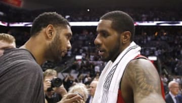 May 14, 2014; San Antonio, TX, USA; San Antonio Spurs forward Tim Duncan (left) hugs Portland Trail Blazers forward LaMarcus Aldridge (right) talk after game five of the second round of the 2014 NBA Playoffs at AT&T Center. The Spurs won 104-82. Mandatory Credit: Soobum Im-USA TODAY Sports